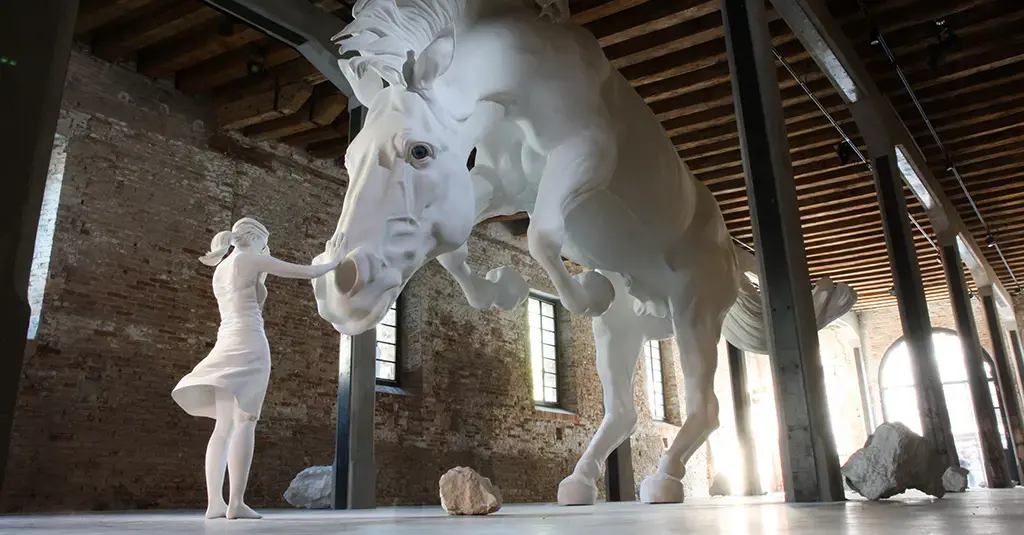The Horse Problem — a giant white horse sculpture rearing over a small blindfolded girl figure in a brick-walled pavilion
